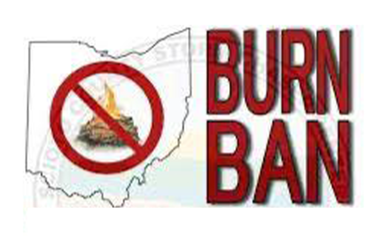 Map of Ohio with a campfire inside a red circle and slash, indicating a prohibition. The words "BURN BAN" are boldly written in red to the right of the map.